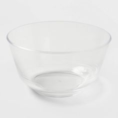 a clear glass bowl sitting on top of a white table