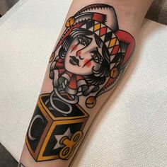 a woman's arm with a tattoo on it and a dice in the middle