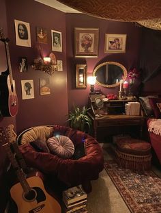 a living room filled with lots of furniture and pictures on the wall next to a guitar