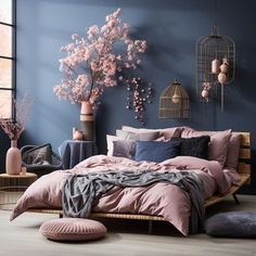 a bedroom with blue walls and pink bedding