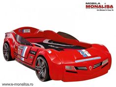 a red sports car bed is shown in this image