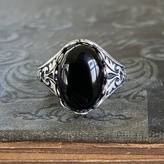 Filigree Ring - Black Onyx Stone in Silver 14x10mm | Ragtrader Vintage Classic Black Adjustable Signet Ring, Adjustable Black Signet Ring With Polished Finish, Classic Adjustable Black Enamel Rings, Black Oval Gothic Jewelry, Vintage Adjustable Black Signet Ring, Vintage Black Adjustable Signet Ring, Gothic Black Oval Jewelry, Black Cabochon Signet Ring For Formal Occasions, Classic Adjustable Jewelry With Black Enamel