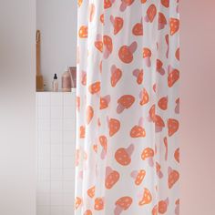 a shower curtain with orange and pink hearts on it