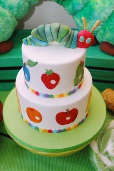 there is a very colorful cake with a caterpillar on the top and sides