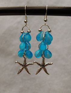 Let the spirit of the tropics surround you as you wear these earrings! The blue tear drop glass beads represent the ocean water. The pewter star fish adds the finishing touch French ear wire is silver plated. Beach Teardrop Jewelry With Dangling Beads, Beach Jewelry With Teardrop Dangling Beads, Teardrop Dangling Beads Jewelry For Beach, Nickel-free Starfish Earrings Ocean-inspired, Ocean-inspired Starfish Charm Dangle Earrings, Beach Dangle Teardrop Earrings With Ear Wire, Nickel-free Silver Beaded Earrings For Beach, Nickel Free Silver Beaded Earrings For Beach, Starfish Charm Dangle Earrings For Jewelry Making