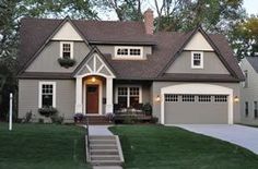 a large house with two garages in the front yard