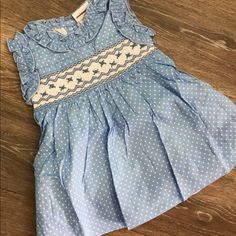 This Is A Really Sweet Dress For A Little Girl With Tulle Trim Underlying The Hem. The Back Has A Bow For Tying Fir An Extra Girly Look. Cute Ruffled Smocked Dress For Dress-up, Fitted Blue Smocked Dress For Playtime, Blue Smocked Dress With Flutter Sleeves And Ruffles, Cute Light Blue Dress With Smocked Back, Blue Smocked Dress With Flutter Sleeve For Summer, Blue Summer Smocked Dress With Flutter Sleeves, Blue Dress With Smocked Bodice For Playtime, Cute Cotton Swiss Dot Dresses, Cute Sleeveless Cotton Smocked Dress