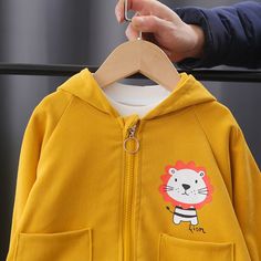 This Lion Cartoon Graphic Print Hooded Jacket is a must-have for the autumn season. It has a zipper lock-up style and is made of cotton materials. Its hooded design makes it even more suitable for keeping your kids warm and comfortable on cold days. Plus, the lion design makes it fashionable and trendy. Features: Perfect for autumn, or any day. Zipper lock-up style. With hood and side pockets. Comfortable to wear. Fabric & Care: Made of high-quality cotton materials. Hand-washed preferred. Do no Yellow Cotton Hoodie With Pockets, Winter Cotton Hooded Jacket With Zipper Closure, Outdoor Cotton Hoodie With Detachable Hood, Cotton Hooded Jacket With Kangaroo Pocket, Cotton Hooded Jacket With Zipper For Outdoor, Outdoor Cotton Hooded Jacket With Zipper, Cotton Hooded Jacket With Zipper For Fall, Outdoor Cotton Hooded Jacket With Zipper Closure, Cotton Hoodie With Detachable Hood