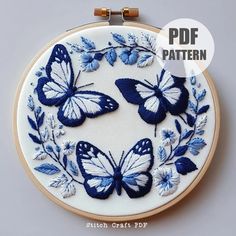 a blue and white embroidery pattern with butterflies on it