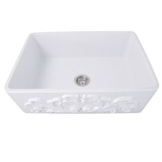 a white sink with an ornate design on the front and bottom edge, sitting against a white background