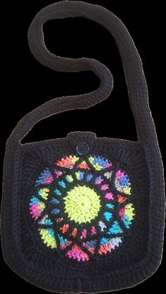 This is a handmade crocheted purse. It is black with a stain glass design in the middle in multiple colors. It is 13 inches wide and 12 1/2 inches long. The strap is 45 inches long and 2 1/2 inches wide. It has a button closer. Crocheted Purse, Stained Glass Designs, Crochet Purses, Stain Glass, Backpack Purse, Glass Design, In The Middle, Purses And Handbags, The Middle