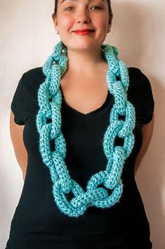 a woman wearing a blue crocheted necklace