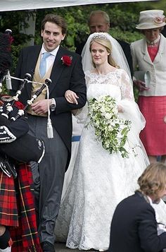 the bride and groom are walking down the aisle with their bagpipes in hand