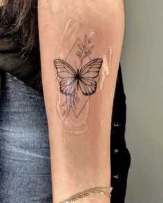 a woman's arm with a tattoo on it and a butterfly in the middle