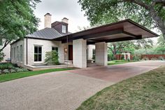 a white house with a large driveway in front of it