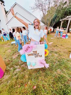 a woman holding a sign that says the sweet little life