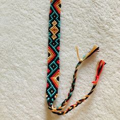 two pieces of beaded bracelets sitting on top of a white towel next to each other