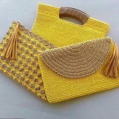 two yellow bags with tassels on them