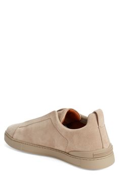 This soft and supple suede sneaker slips on easily with crisscrossed elastic at the vamp and is set on a tonal rubber cupsole for a casual aesthetic. Pull-on style Leather upper and lining/synthetic sole Made in Italy Designer Shoes Modern Suede Slip-on Sneakers, Slip-on Sneakers With Suede Lining, Casual Suede Slip-on Sneakers, Casual Slip-on Sneakers With Suede Lining, Spring Suede Slip-on Sneakers, Modern Suede Slip-on Sneakers With Rubber Sole, Suede Slip-on Sneakers With Leather Sole And Round Toe, Slip-on Sneakers With Suede Lining And Round Toe, Spring Suede Low-top Slip-ons