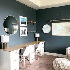 a living room with blue walls and white furniture in the corner, along with pictures on the wall