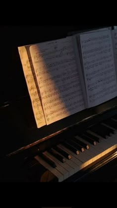 an open book sitting on top of a piano