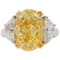 This gorgeous 10.03 carat fancy yellow diamond is like wearing a piece of sunshine! Exceptionally sparkly and with beautifully vibrant color, this is a truly magnificent piece. Graded by GIA as a fancy yellow color and VS2 clarity, the center diamond is set in 18K yellow gold so the prongs will disappear against the stone. Two half moon diamonds which total 2.41 carats provide brilliance contrast against the yellow center diamond. The rest of the setting is crafted in platinum with an open, airy Dig Jewelry, Radiant Cut Ring, Asscher Cut Diamond Ring, Big Diamonds, Fancy Yellow Diamond Ring, Radiant Cut Diamond Ring, Fancy Diamond Ring, Yellow Diamond Ring, Canary Diamond