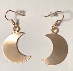 I've designed a pair of crescent moon earrings, 1 1/8 inches each in size, with dangling ear hook wires. The set is completely handmade in sterling silver. Inspired by Stevie Nicks, I wanted to fabricate matching earrings to the moon pendant and as this was for a customer request, I thought, what a grand idea! I can offer a 24K gold plating option that I will include in the drop down menu at checkout! The last image is to show the crescent moon necklace. Please convo for any questions! Allow me Gold Crescent Earrings With Moon Phase Detail, Metal Moon-shaped Hoop Earrings, Gold Half Moon Earrings With Moon Charm, Nickel-free Crescent Celestial Earrings, Celestial Crescent Moon Phase Earrings, Half Moon Phase Brass Earrings, Celestial Half Moon Earrings With Moon Phase Detail, Brass Earrings With Moon Charm In Half Moon Shape, Brass Half Moon Earrings