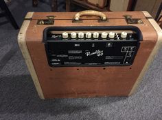 an old amp is sitting on the floor