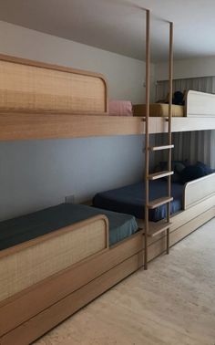 a room with bunk beds and ladders in it