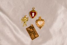 The Lovers Vintage Charm Lot includes: 1 Vintage Red Cameo Heart Locket Charm, 1 Vintage I Love You Postcard Charm, 1 Vintage Pearl Heart Charm, and 1 Vintage Cupid Charm. All charms are brass and may need to be touched up with a jewelry cloth to keep them sparkling! Not to worry I include a jewelry cloth with every order BUILD YOUR OWN CUSTOM CHARM NECKLACE here: https://cloakedinconfidence.etsy.com/listing/1660083621 This charm comes with a gold filled jump ring ready to slide on any chain you might have or to use for jewelry making projects♡ If you need a chain please check out my gold filled everyday paperclip chain: https://www.cloakedinconfidence.co/product-page/large-paperclip-chain This listing is for all brass charms included in the picture. These charms are all light weight and e Valentine's Day Vintage Charm Necklaces, Vintage Charm Necklace With Heart Charm For Anniversary, Vintage Heart Charm Necklace For Keepsake, Vintage Heart Charm Necklaces For Valentine's Day, Vintage Charm Necklaces For Anniversary On Valentine's Day, Vintage Heart-shaped Keepsake Charm Necklace, Vintage Heart Pendant Charm Necklace For Valentine's Day, Vintage Heart Pendant Charm Necklace For Wedding, Vintage Heart Pendant Charm Necklace