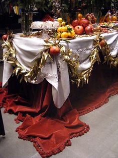 the table is covered with fruit and silverware for an elegant touch to it's setting