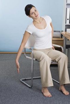 a woman sitting on a chair in an office