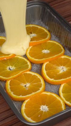 oranges are being poured into a pan with ice