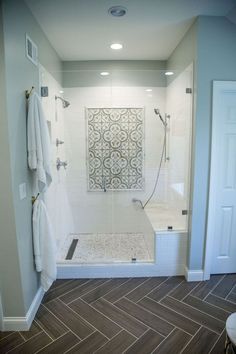 a bathroom with white fixtures and wood flooring