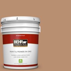 the behr paint and primer in one is shown on a gray background with red trim