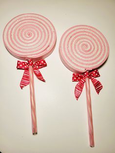 two candy lollipops with bows on them