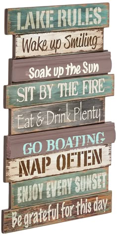 a wooden sign that says lake rules wake up smiling sit by the fire eat & drink plenty go boating nap often enjoy sunset be grateful for this day