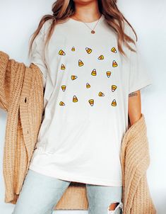 Matching sweatshirt: https://peachleafstore.etsy.com/listing/1046614652 ❀ Design is printed directly onto the t-shirt. ❀ More color options might be available upon request.  ❀ Size up if you want it oversized. ❀ The sizing is unisex. For garment measurements, please take a look at the size guide included in the listing images. Washing instructions to best preserve the print: ❀ Wash inside out using mild detergent, on a low temperature setting.  ❀ Let hang dry (do not tumble dry). Shop Homepage: Fun White T-shirt For Fall, White T-shirt With Funny Print For Fall, Fun Custom Print Tops For Fall, White Custom Print Shirt For Fall, Candy Corn Shirt, Corn Shirt, Halloween Shirts For Women, Last Minute Halloween Costume, Small Business Design