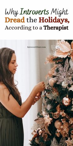 a woman decorating a christmas tree with text overlay that reads, why introverts might dread the holidays according to a therapy