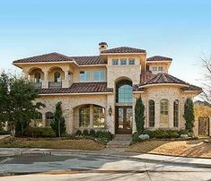 a large house with lots of windows and landscaping