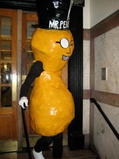 a person in a costume standing next to a door