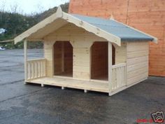 a wooden dog house sitting on top of a parking lot