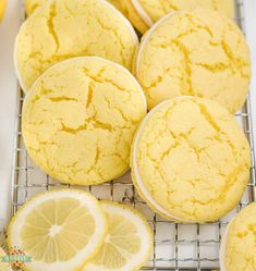 lemon muffins on a cooling rack with slices of lemon