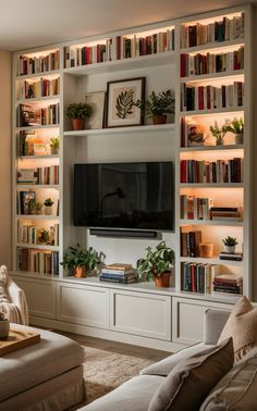 a living room filled with lots of furniture and bookshelves covered in shelves full of books