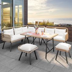 an outdoor patio furniture set with white cushions