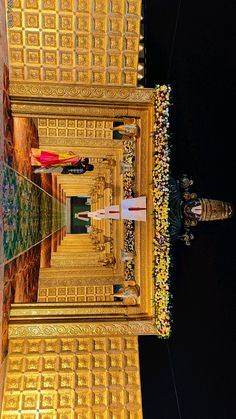 the reflection of an ornate golden building in water