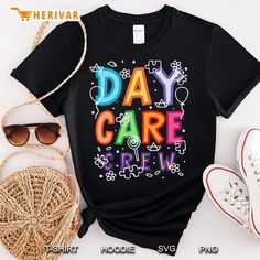 a t - shirt that says day care crew on it next to some shoes and sunglasses