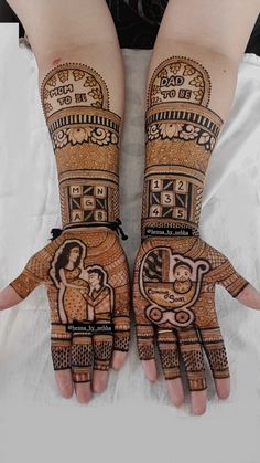 two hands with henna designs on them