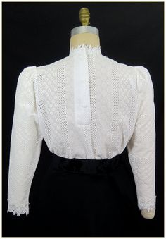 "100% Cotton. Color: White. Embroidered stripe pattern weave cotton fabric with white poly floral leaf lace trim. Poly trim for collar, cuffs and front bodice, classic Edwardian design. Lightly gathered full length sleeves with button back. Generously cut for comfort. Machine washable. Circa 1898-1910. Made in U.S.A. Sizes: SM, MED, LG & XLG. Blouses ordered by bust measurement, inches: BUST SIZES 32\" - 34\" SMALL 35\" - 39\" MEDIUM 40\" - 44\" LARGE 45\" - 49\" XLARGE Blouses ordered by bu Elegant Cotton Lace Patchwork Tops, Elegant Cotton Top With Lace Patchwork, Cotton Blouse With Lace Patchwork For Daywear, Fitted Cotton Lace Blouse With Lace Trim, Elegant Cotton Blouse With Lace Patchwork, Classic Blouse With Lace Cuffs For Work, Elegant Cotton Lace Blouse For Spring, Classic Cotton Blouse With Lace Trim, Victorian Cotton Fitted Blouse