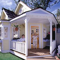 a small white house with two people in the front door and on the back porch